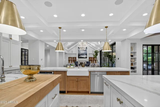 a spacious bathroom with a double vanity sink a mirror and a