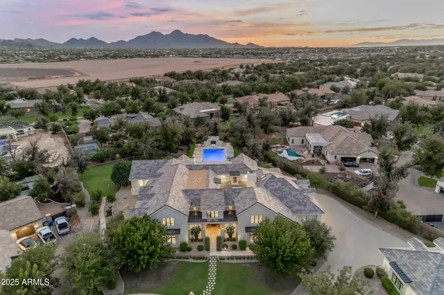 a living room with furniture a fireplace and a chandelier