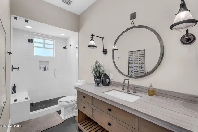 a kitchen with stainless steel appliances granite countertop a stove a sink a dining table and chairs with wooden floor