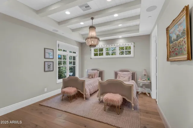 a bedroom with a bed and a chandelier
