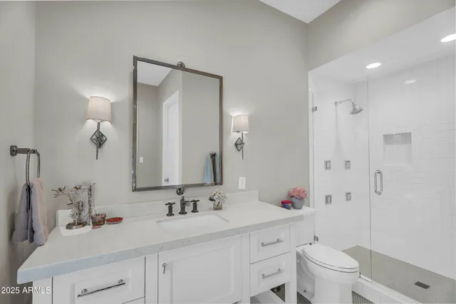 a bedroom with a bed chandelier and a window