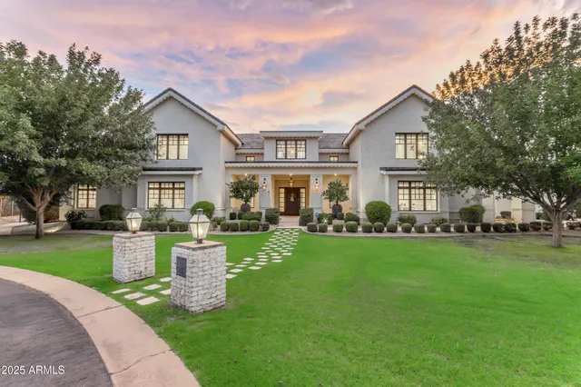a living room with fireplace furniture and a large window