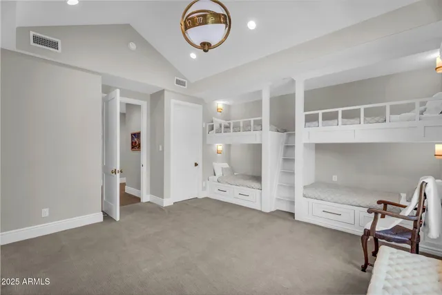 a view of a swimming pool with a table and chairs under an umbrella