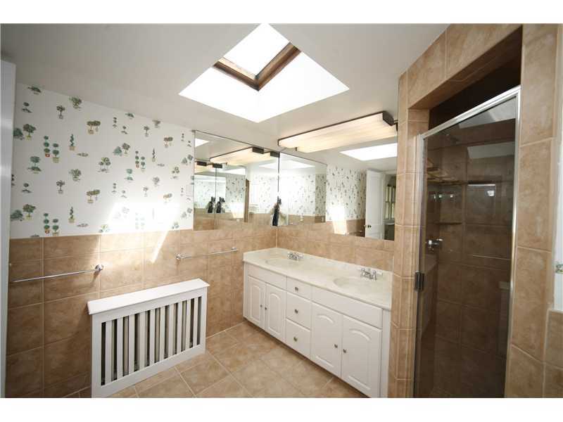 96 Rose Lane Darien, CT 06820 - Photo 14 of 23 a bathroom with a sink a mirror and a shower