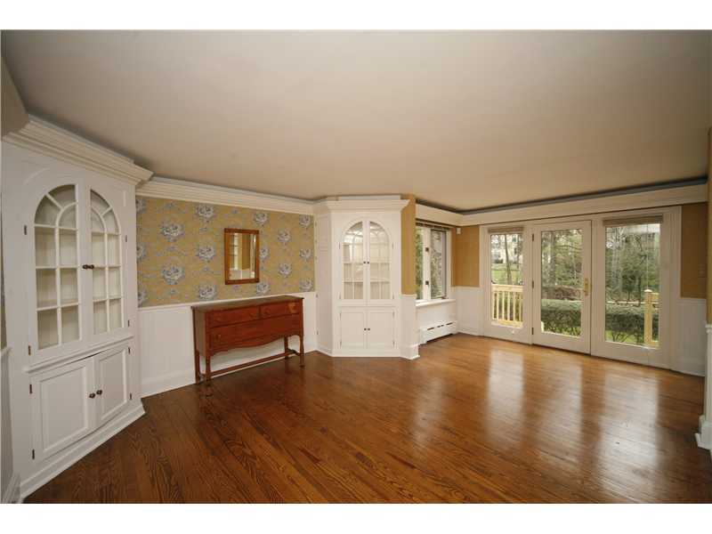 96 Rose Lane Darien, CT 06820 - Photo 3 of 23 a view of an empty room with wooden floor and a window