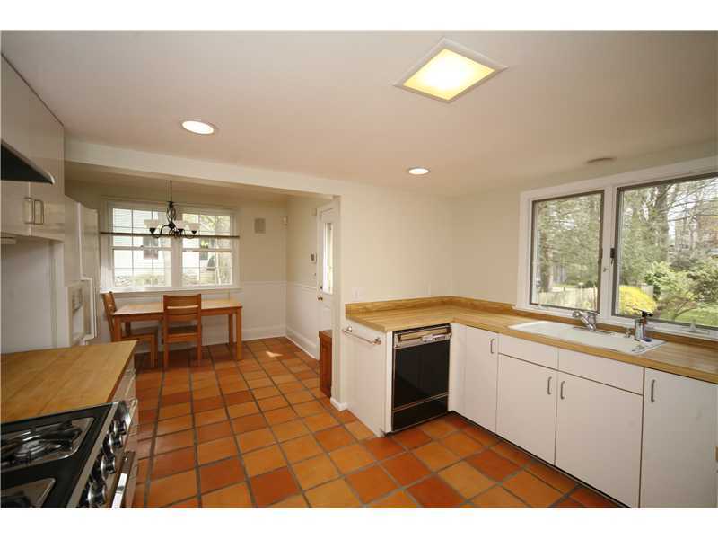 96 Rose Lane Darien, CT 06820 - Photo 9 of 23 a kitchen with a stove a sink and a refrigerator