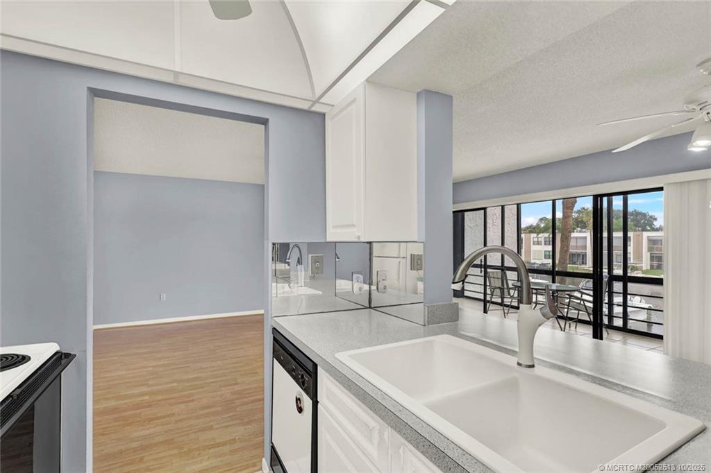 1950 Southwest Palm City Road, Unit 3207 Stuart, FL 34994 - Photo 19 of 44 a kitchen with a sink cabinets and a large window