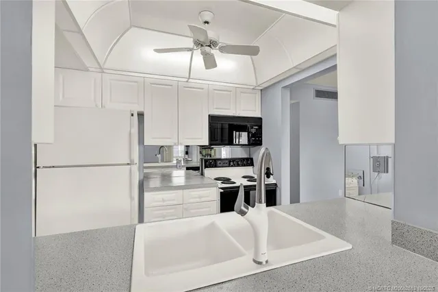 a kitchen with stainless steel appliances a refrigerator a stove and a sink