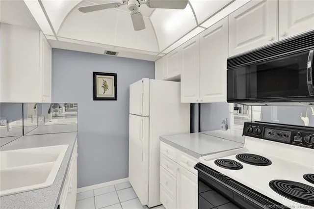 a kitchen with a refrigerator and a sink
