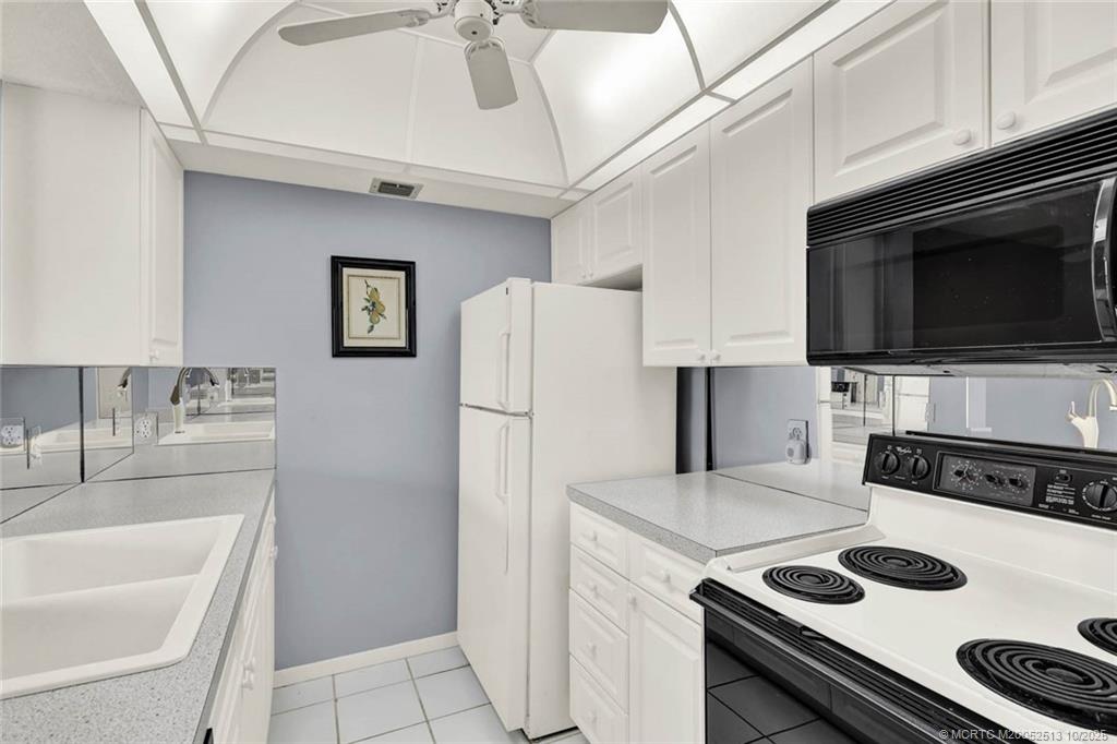 1950 Southwest Palm City Road, Unit 3207 Stuart, FL 34994 - Photo 22 of 44 a kitchen with a refrigerator and a sink