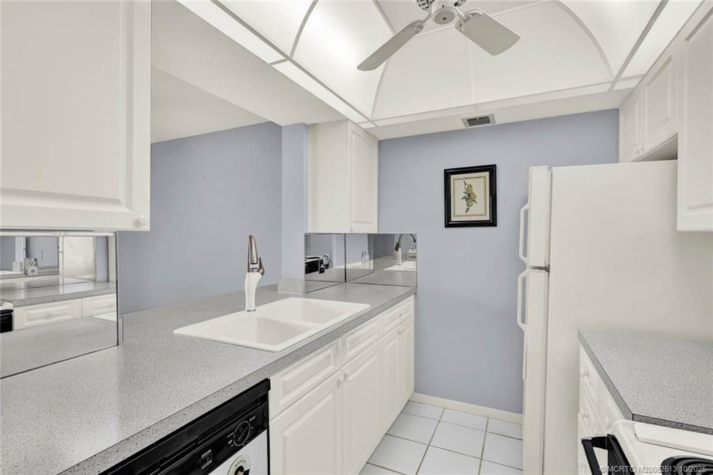 1950 Southwest Palm City Road, Unit 3207 Stuart, FL 34994 - Photo 23 of 44 a kitchen with a sink appliances and cabinets
