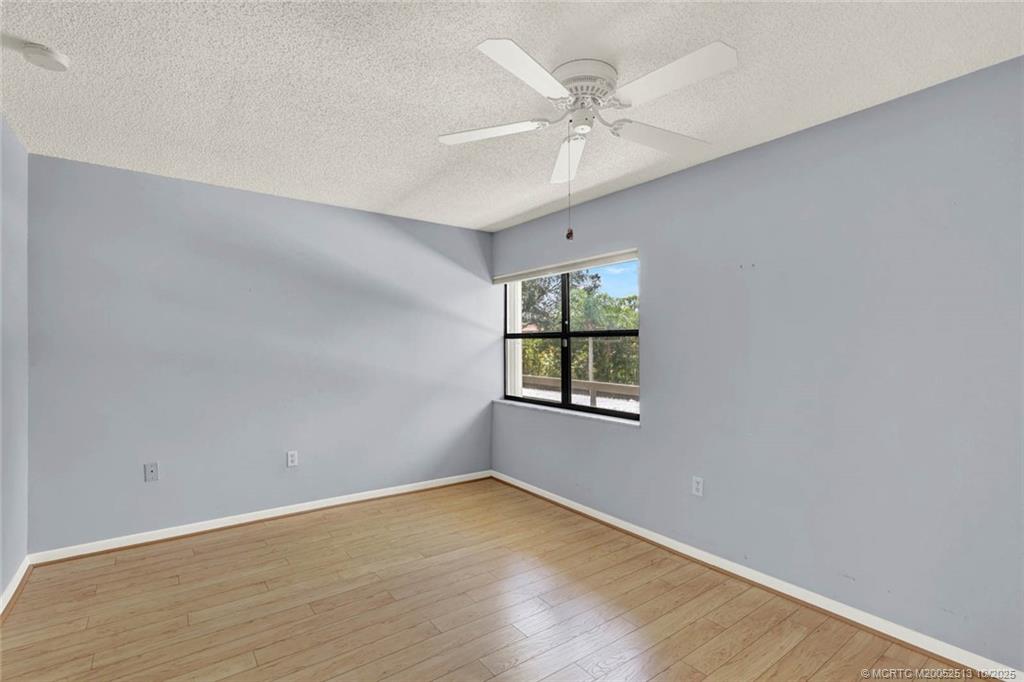 1950 Southwest Palm City Road, Unit 3207 Stuart, FL 34994 - Photo 25 of 44 wooden floor in an empty room with a window