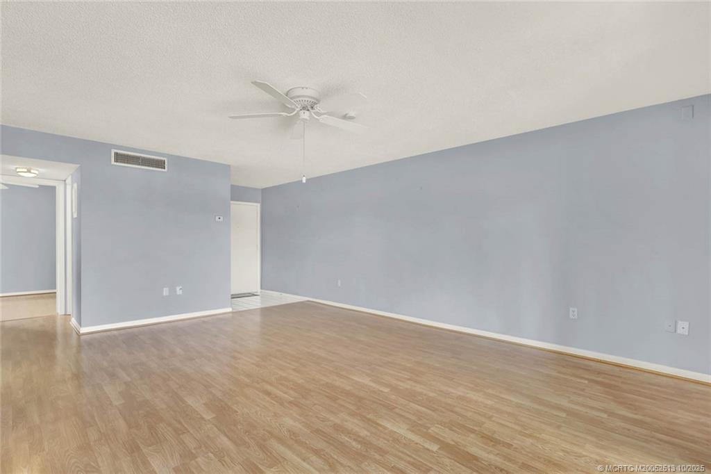 1950 Southwest Palm City Road, Unit 3207 Stuart, FL 34994 - Photo 7 of 44 a view of an empty room with wooden floor