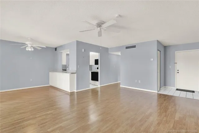 a view of a kitchen with a sink and a refrigerator
