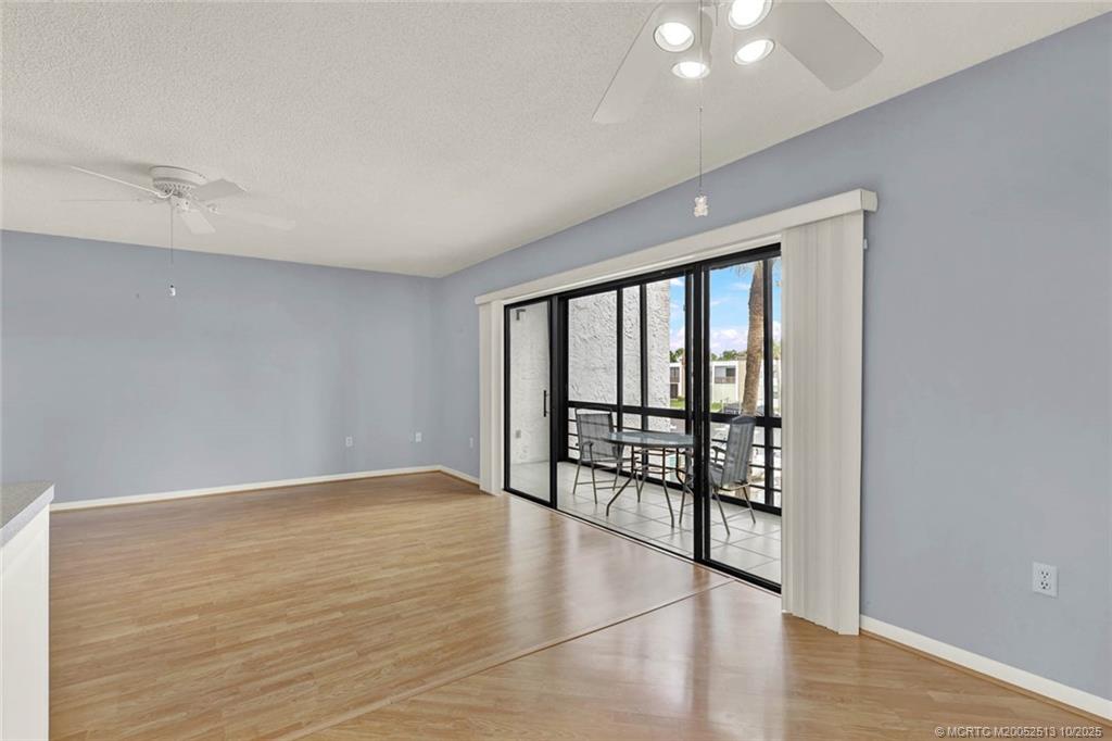 1950 Southwest Palm City Road, Unit 3207 Stuart, FL 34994 - Photo 9 of 44 wooden floor in an empty room with a window