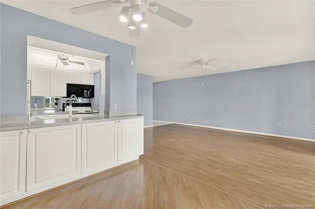 a view of a kitchen with microwave and cabinets