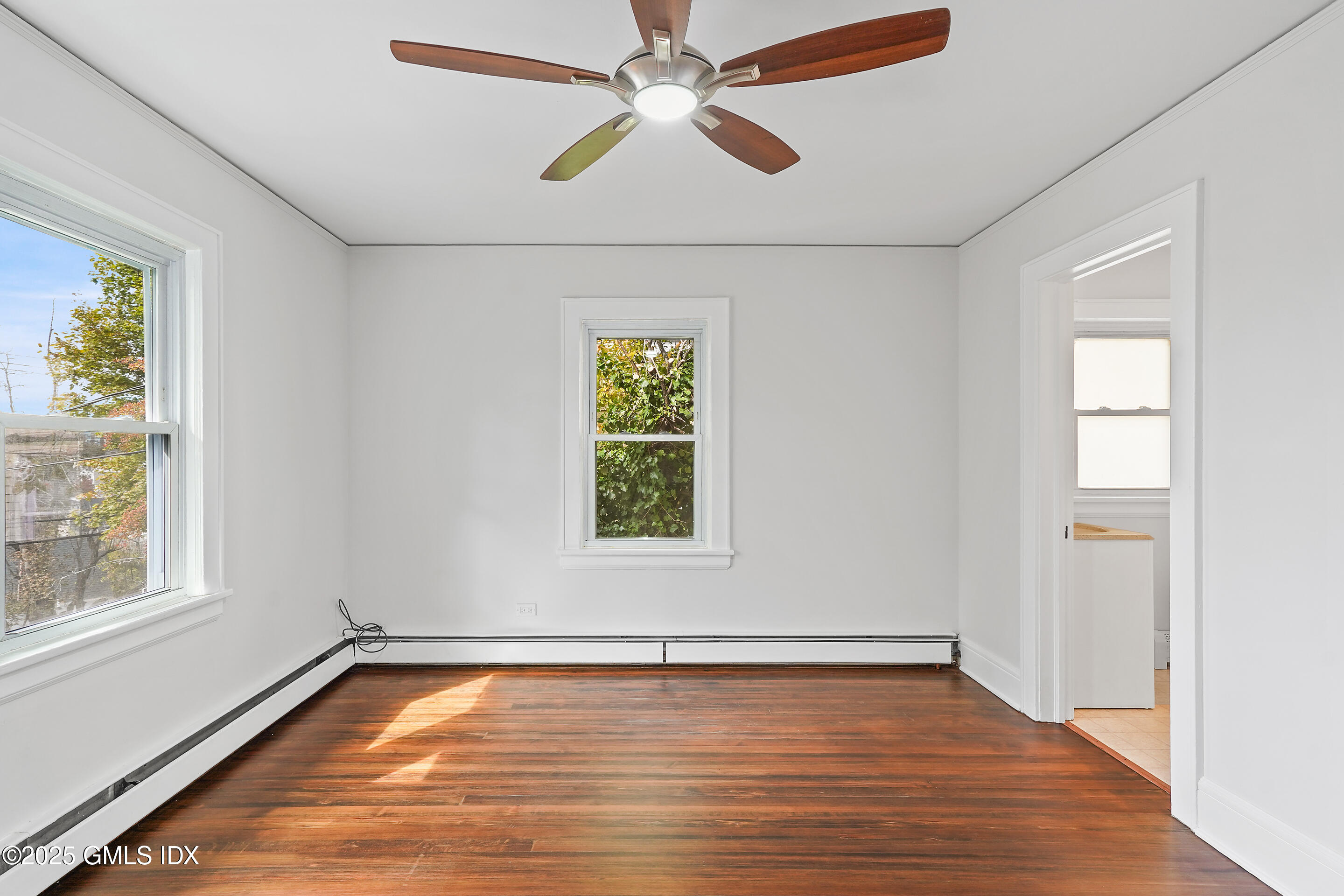 95 Byram Road Greenwich, CT 06830 - Photo 14 of 35 a view of an empty room with window and wooden floor