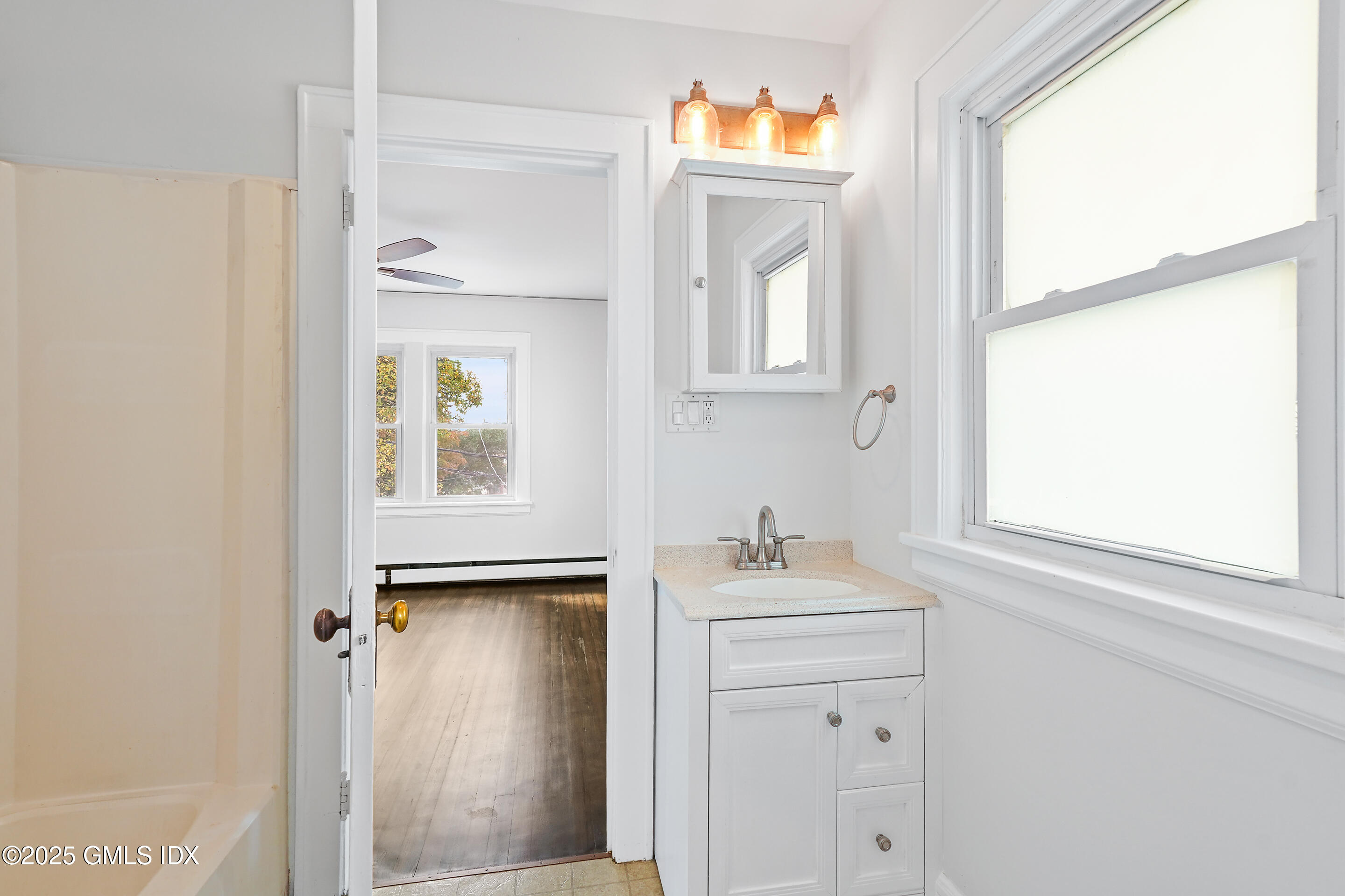 95 Byram Road Greenwich, CT 06830 - Photo 17 of 35 a bathroom with a sink a mirror and window
