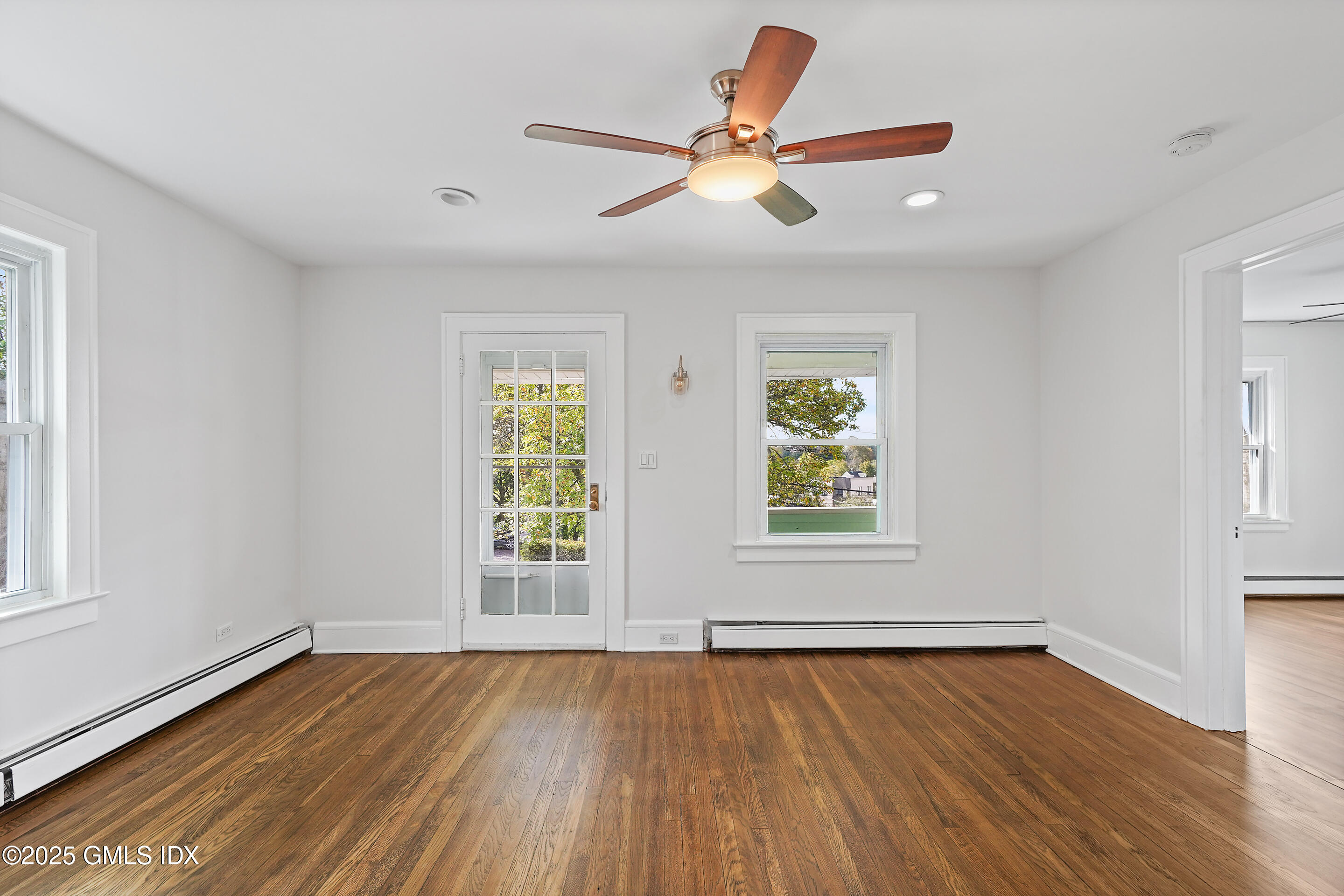 95 Byram Road Greenwich, CT 06830 - Photo 4 of 35 a view of an empty room with wooden floor and a window