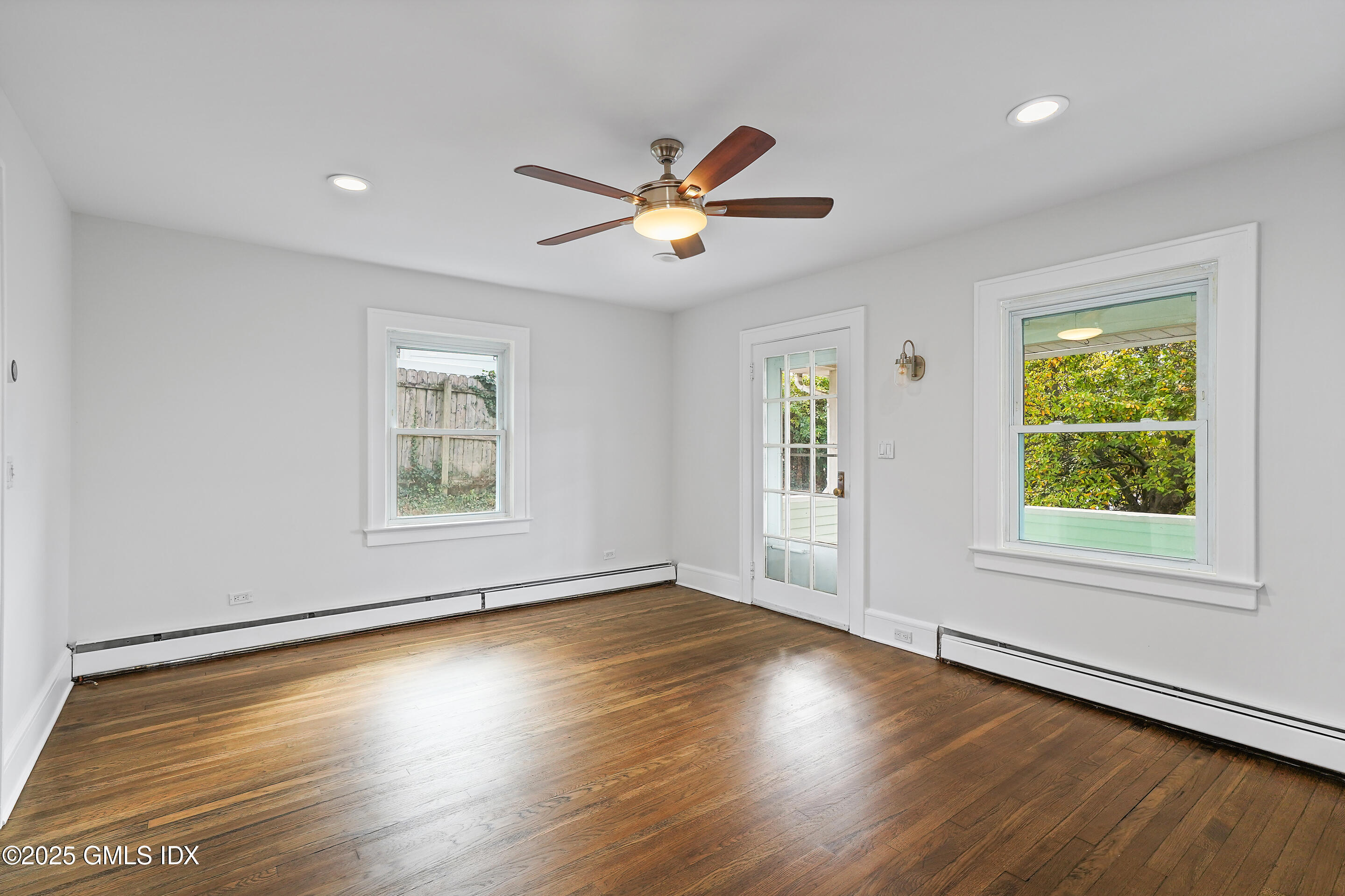 95 Byram Road Greenwich, CT 06830 - Photo 7 of 35 a view of an empty room with wooden floor and a window