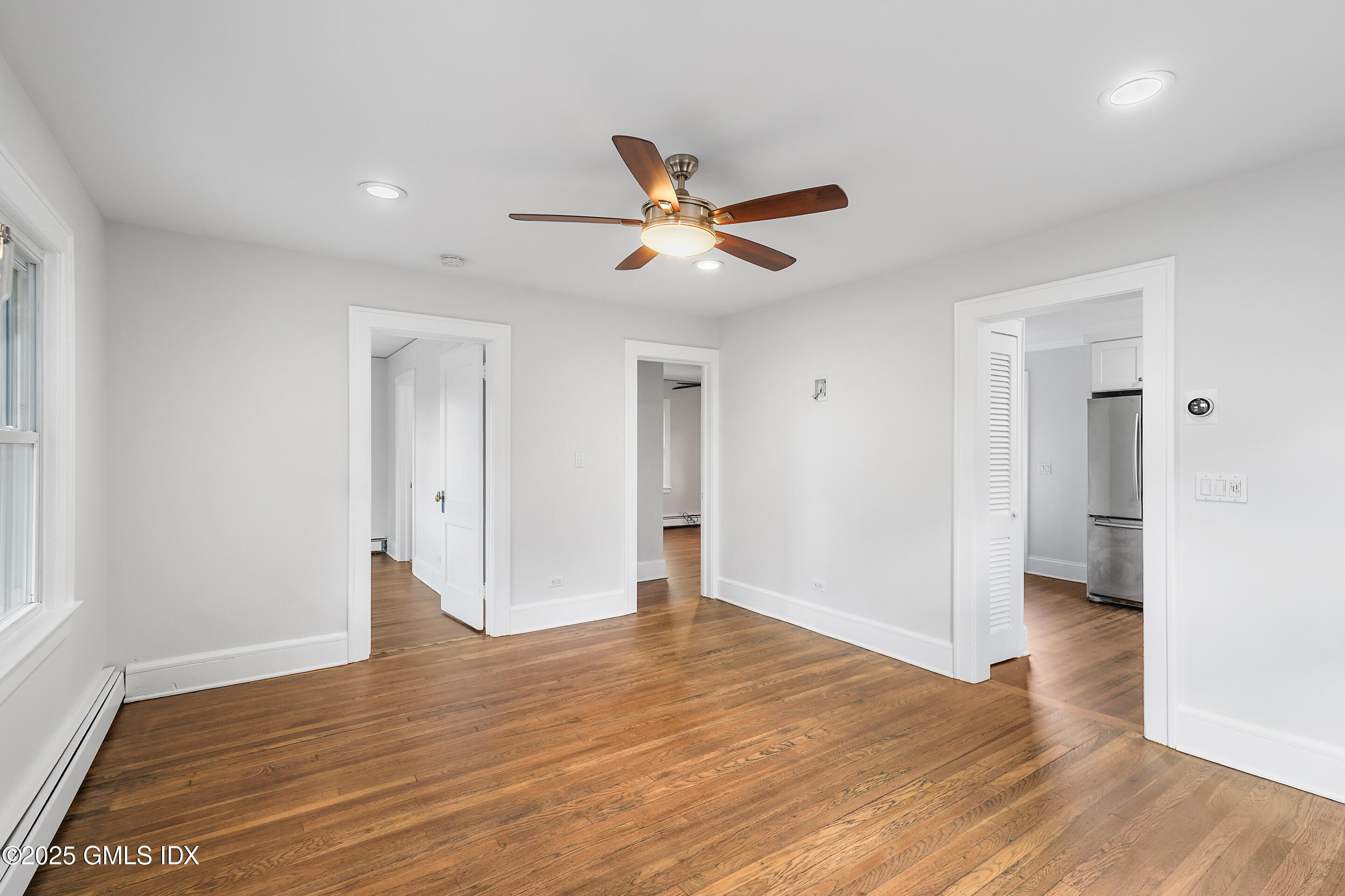 95 Byram Road Greenwich, CT 06830 - Photo 9 of 35 a view of an empty room and wooden floor and a ceiling fan