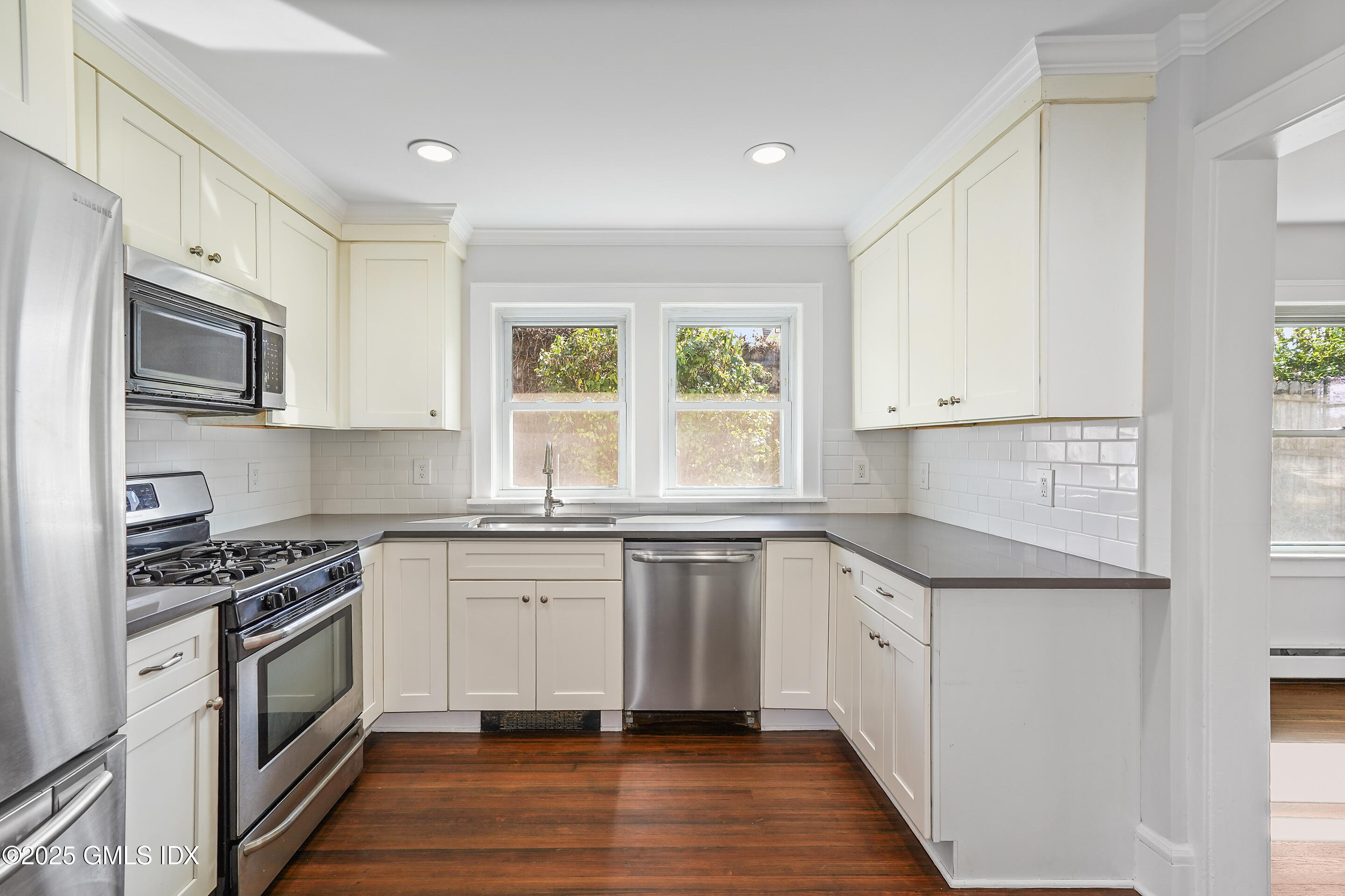 95 Byram Road Greenwich, CT 06830 - Photo 10 of 35 a kitchen with granite countertop a sink cabinets stainless steel appliances and a window