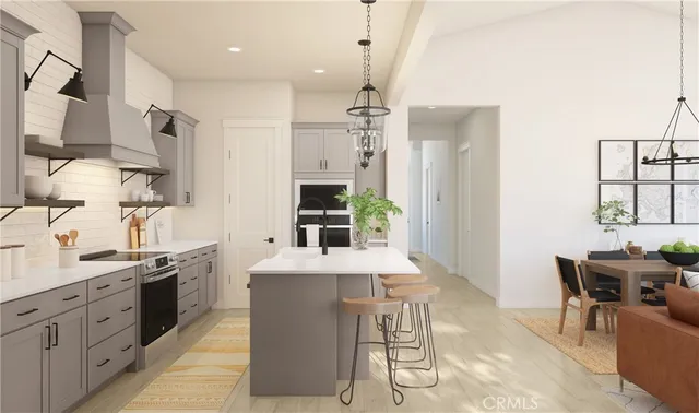 a kitchen with stainless steel appliances kitchen island granite countertop a sink and a refrigerator