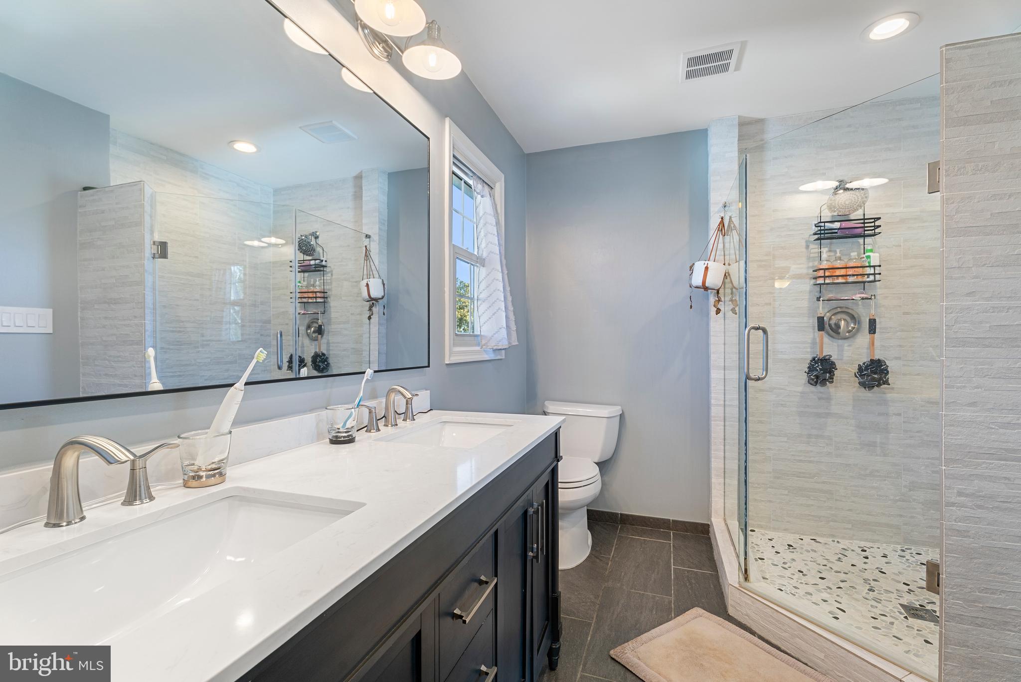 3100 Franklin Street Alexandria, VA 22306 - Photo 35 of 55 a bathroom with a sink double vanity granite toilet and shower