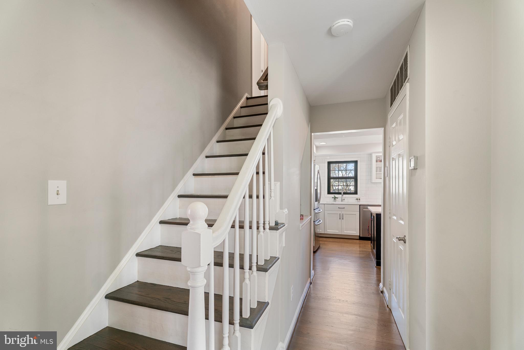 3100 Franklin Street Alexandria, VA 22306 - Photo 4 of 55 a view of staircase with wooden floor and white walls
