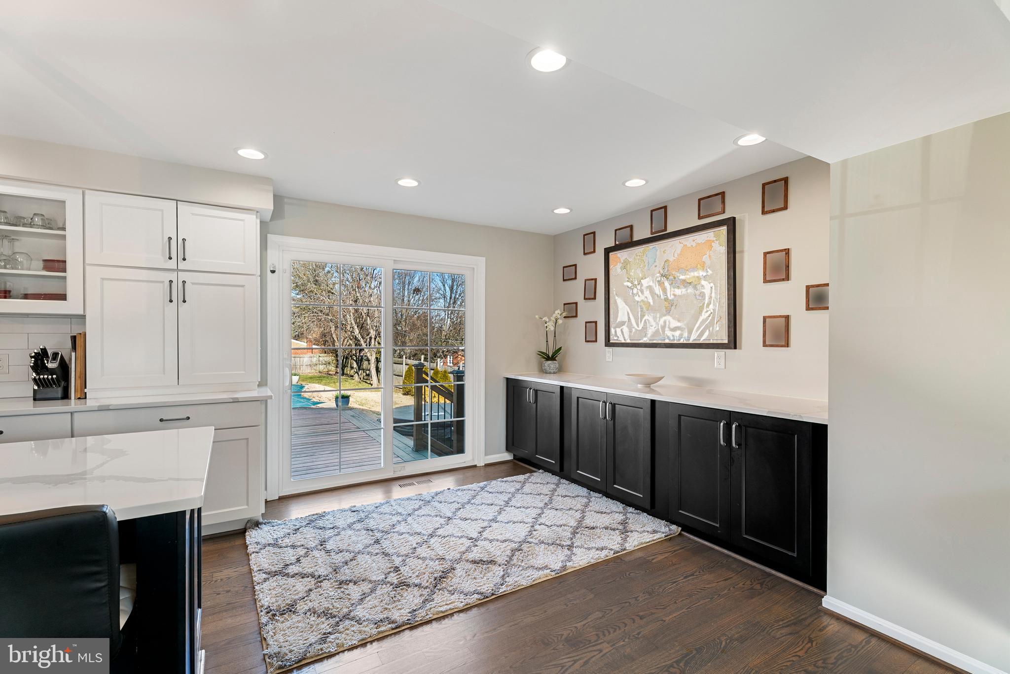 3100 Franklin Street Alexandria, VA 22306 - Photo 10 of 55 a kitchen with stainless steel appliances granite countertop a refrigerator a sink a stove a dining table and chairs with wooden floor