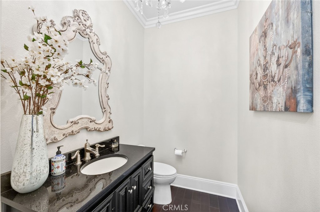 41515 Vía Del Monte Temecula, CA 92592 - Photo 17 of 64 a bathroom with a granite countertop sink a toilet and a mirror