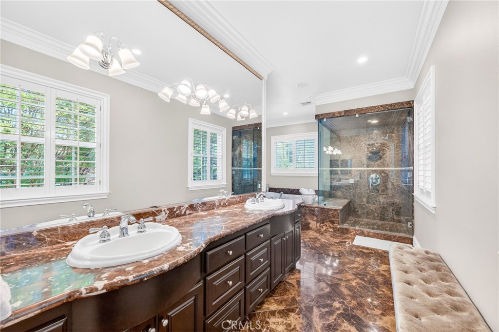 41515 Vía Del Monte Temecula, CA 92592 - Photo 28 of 64 a bathroom with a granite countertop sink and a large mirror