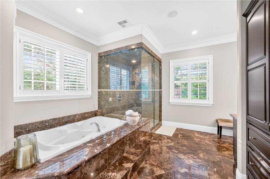41515 Vía Del Monte Temecula, CA 92592 - Photo 30 of 64 a spacious bathroom with a granite countertop tub a sink and a large window
