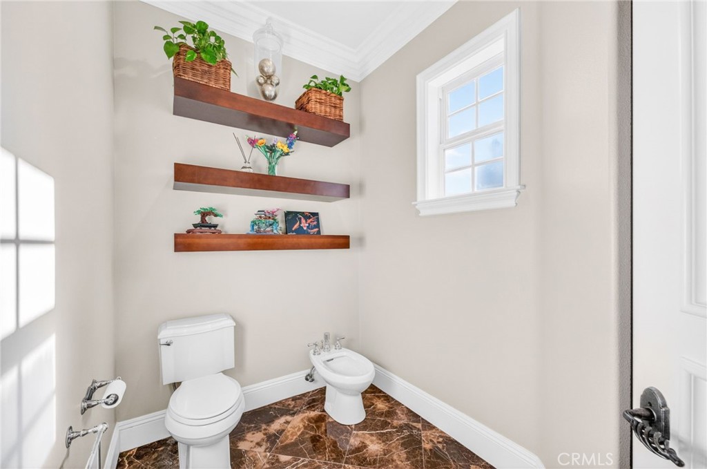 41515 Vía Del Monte Temecula, CA 92592 - Photo 31 of 64 a white toilet sitting next to a bathroom sink and vanity