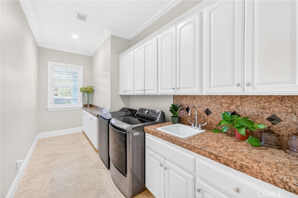41515 Vía Del Monte Temecula, CA 92592 - Photo 33 of 64 a kitchen with stainless steel appliances granite countertop a sink a stove and a white cabinets