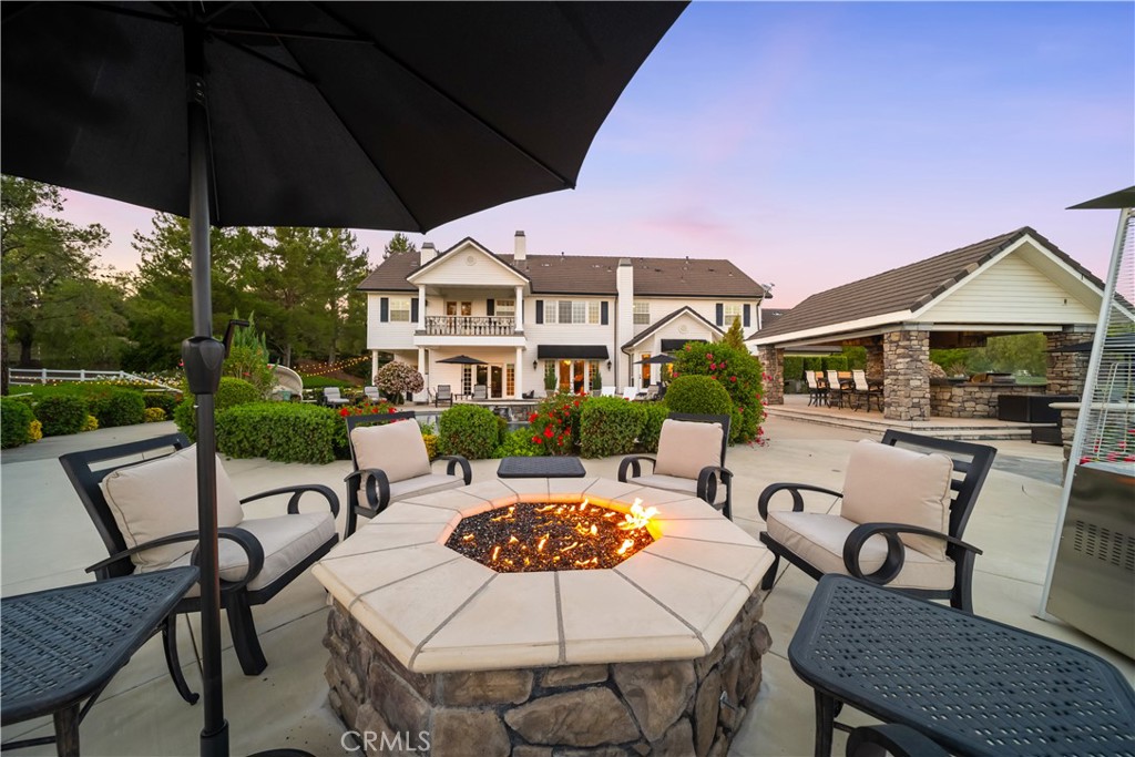 41515 Vía Del Monte Temecula, CA 92592 - Photo 37 of 64 a view of a patio with table and chairs under an umbrella