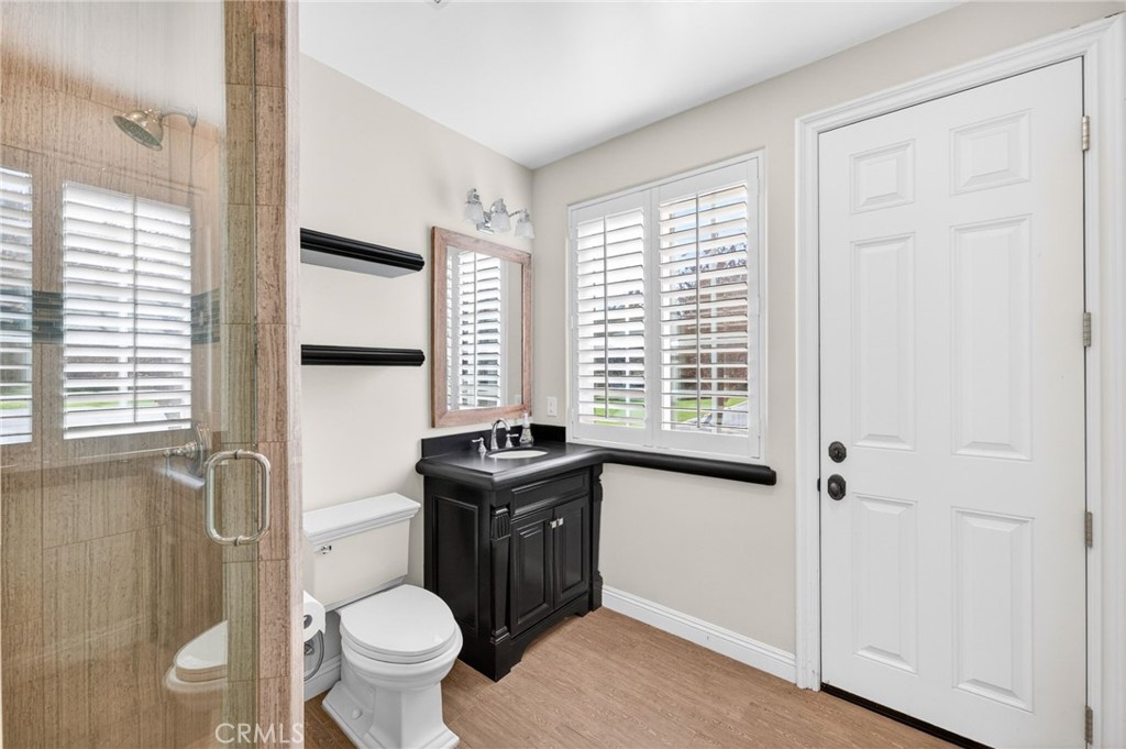41515 Vía Del Monte Temecula, CA 92592 - Photo 46 of 64 a bathroom with a granite countertop toilet a sink and a window