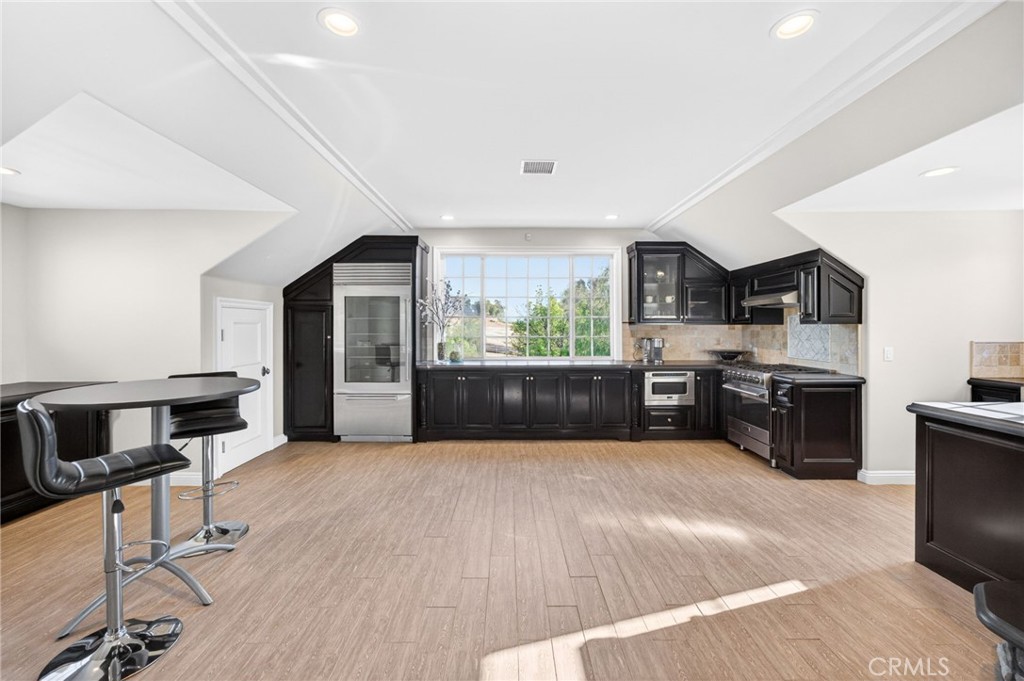 41515 Vía Del Monte Temecula, CA 92592 - Photo 48 of 64 a large kitchen with stainless steel appliances and a refrigerator