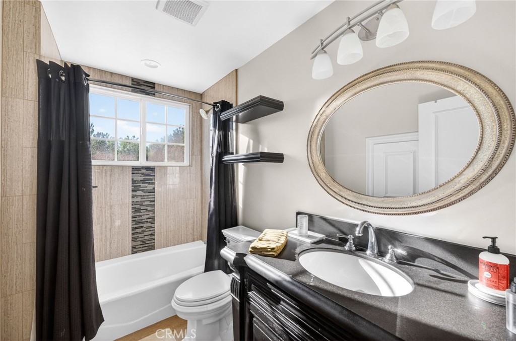 41515 Vía Del Monte Temecula, CA 92592 - Photo 52 of 64 a bathroom with a granite countertop toilet a sink and a mirror