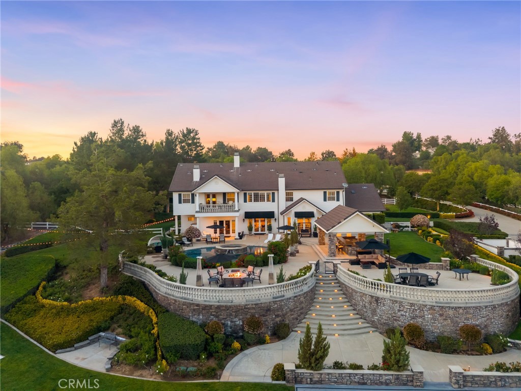 41515 Vía Del Monte Temecula, CA 92592 - Photo 64 of 64 a front view of a house with a garden and lake view