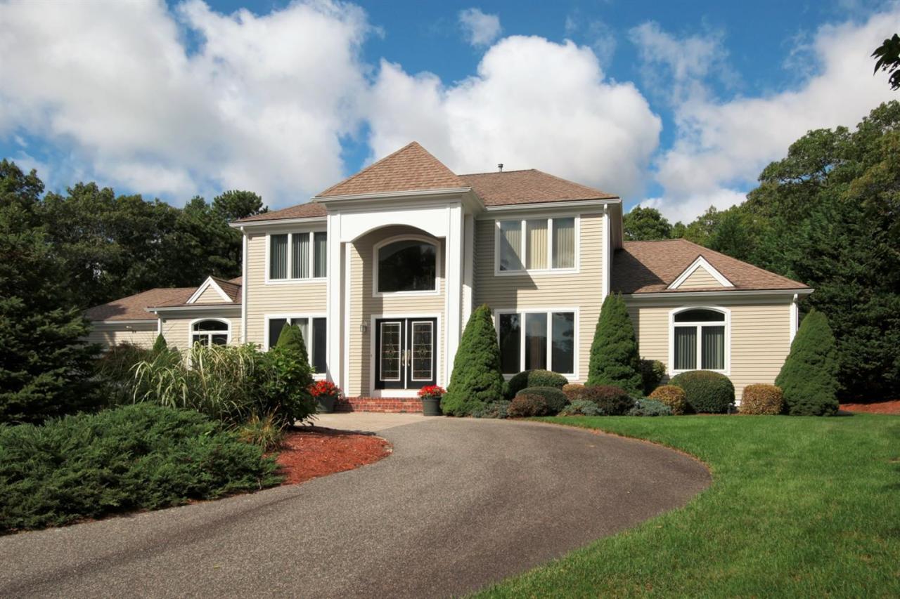 153 Cairn Ridge Road East Falmouth, MA 02536 - Photo 1 of 25 a front view of a house with a yard