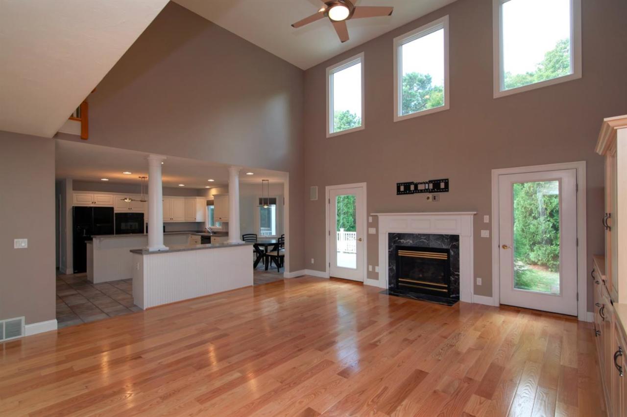 153 Cairn Ridge Road East Falmouth, MA 02536 - Photo 16 of 25 an empty room with wooden floor a fireplace and windows