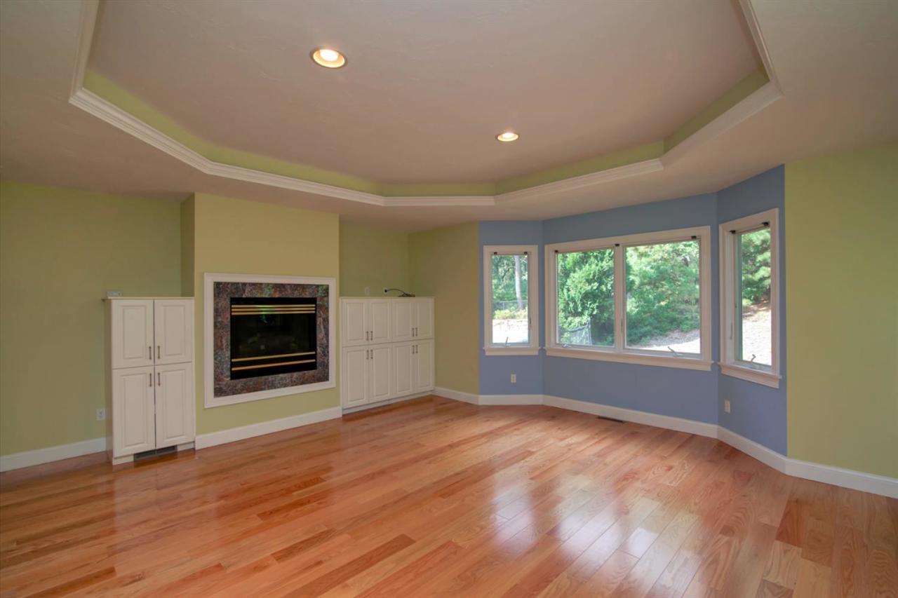 153 Cairn Ridge Road East Falmouth, MA 02536 - Photo 17 of 25 a view of empty room with a fireplace and wooden floor