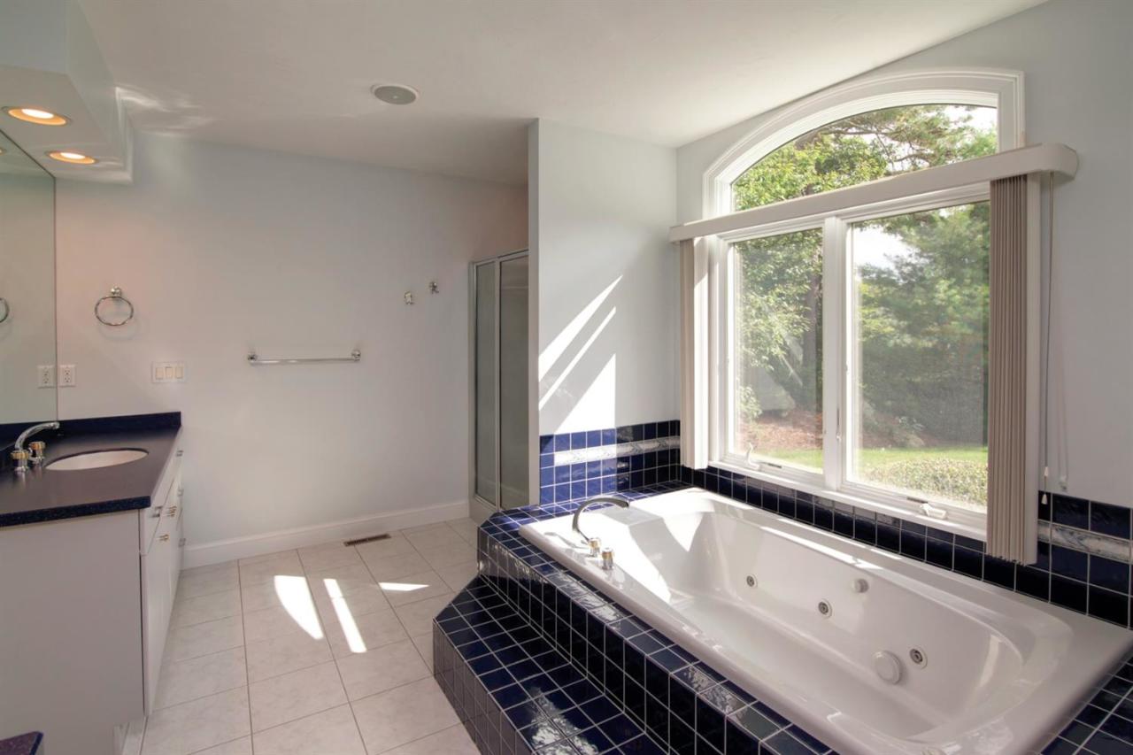 153 Cairn Ridge Road East Falmouth, MA 02536 - Photo 18 of 25 a bathroom with a granite countertop sink and a large window