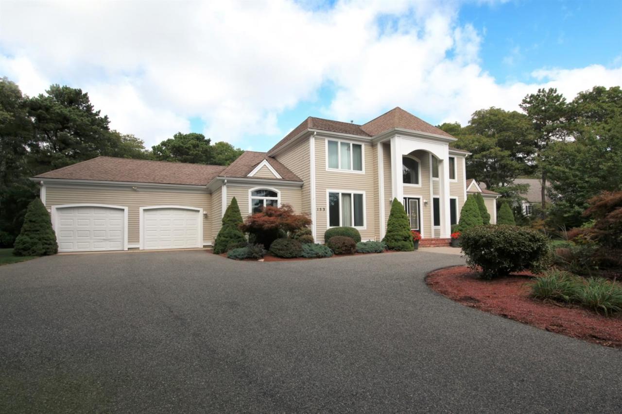 153 Cairn Ridge Road East Falmouth, MA 02536 - Photo 2 of 25 a view of a white house with a yard and large trees
