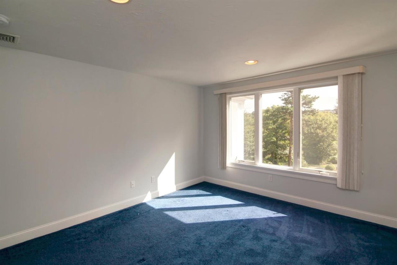 153 Cairn Ridge Road East Falmouth, MA 02536 - Photo 21 of 25 an empty room with wooden floor and windows