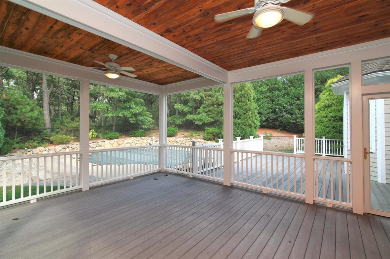 153 Cairn Ridge Road East Falmouth, MA 02536 - Photo 3 of 25 a view of a deck with wooden floor and fence with a floor to ceiling window