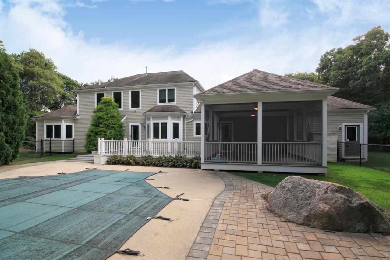 153 Cairn Ridge Road East Falmouth, MA 02536 - Photo 4 of 25 a front view of a house with a garden