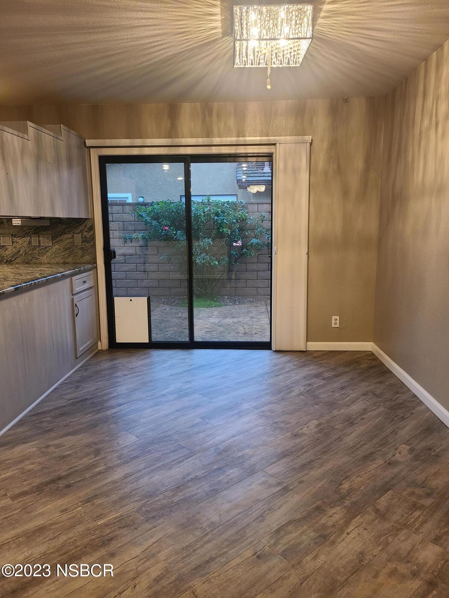 1205 North B Street Lompoc, CA 93436 - Photo 20 of 39 a view of a room with wooden floor and a window