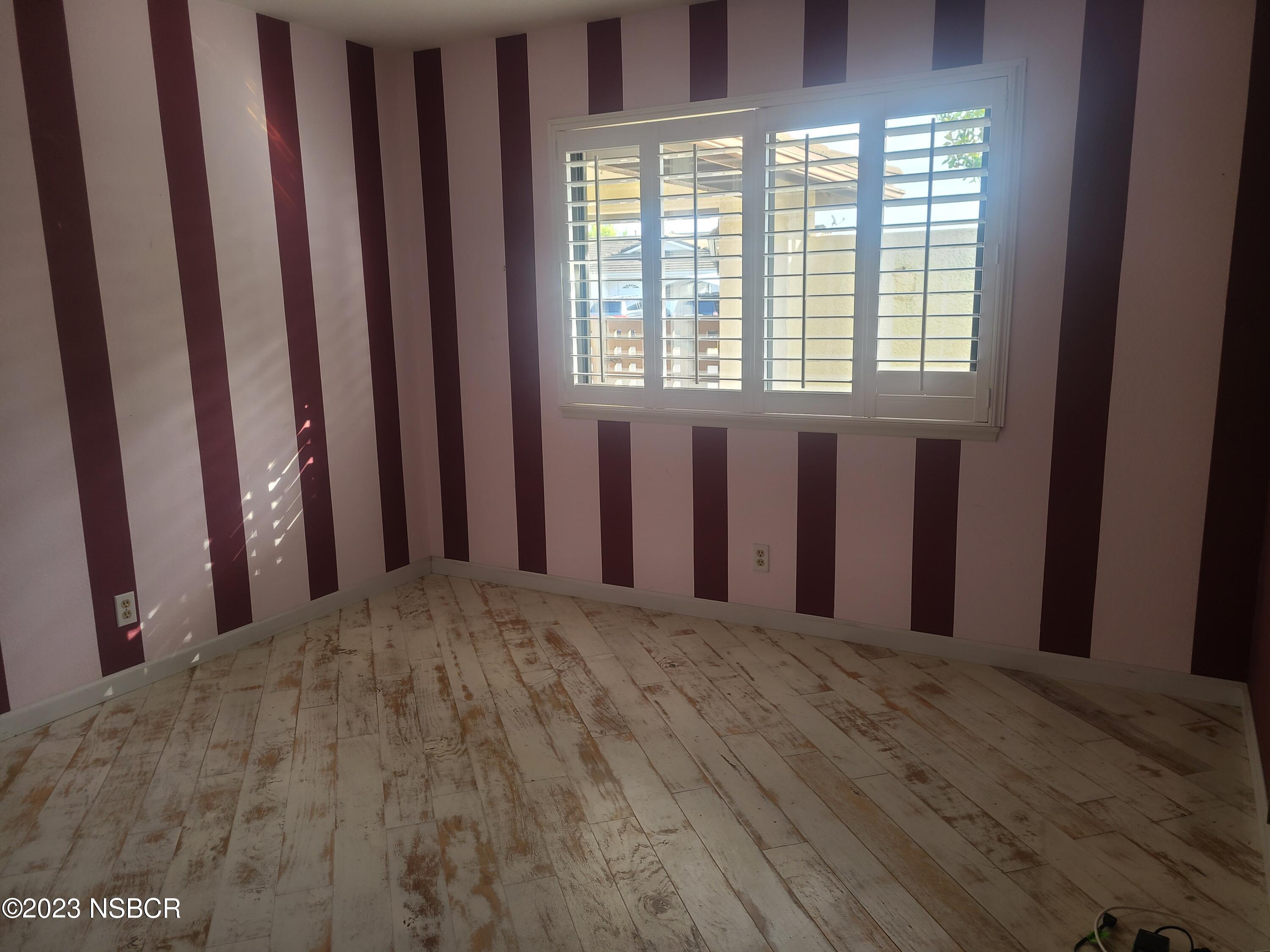 1205 North B Street Lompoc, CA 93436 - Photo 21 of 39 a view of a room with a window and wooden floor